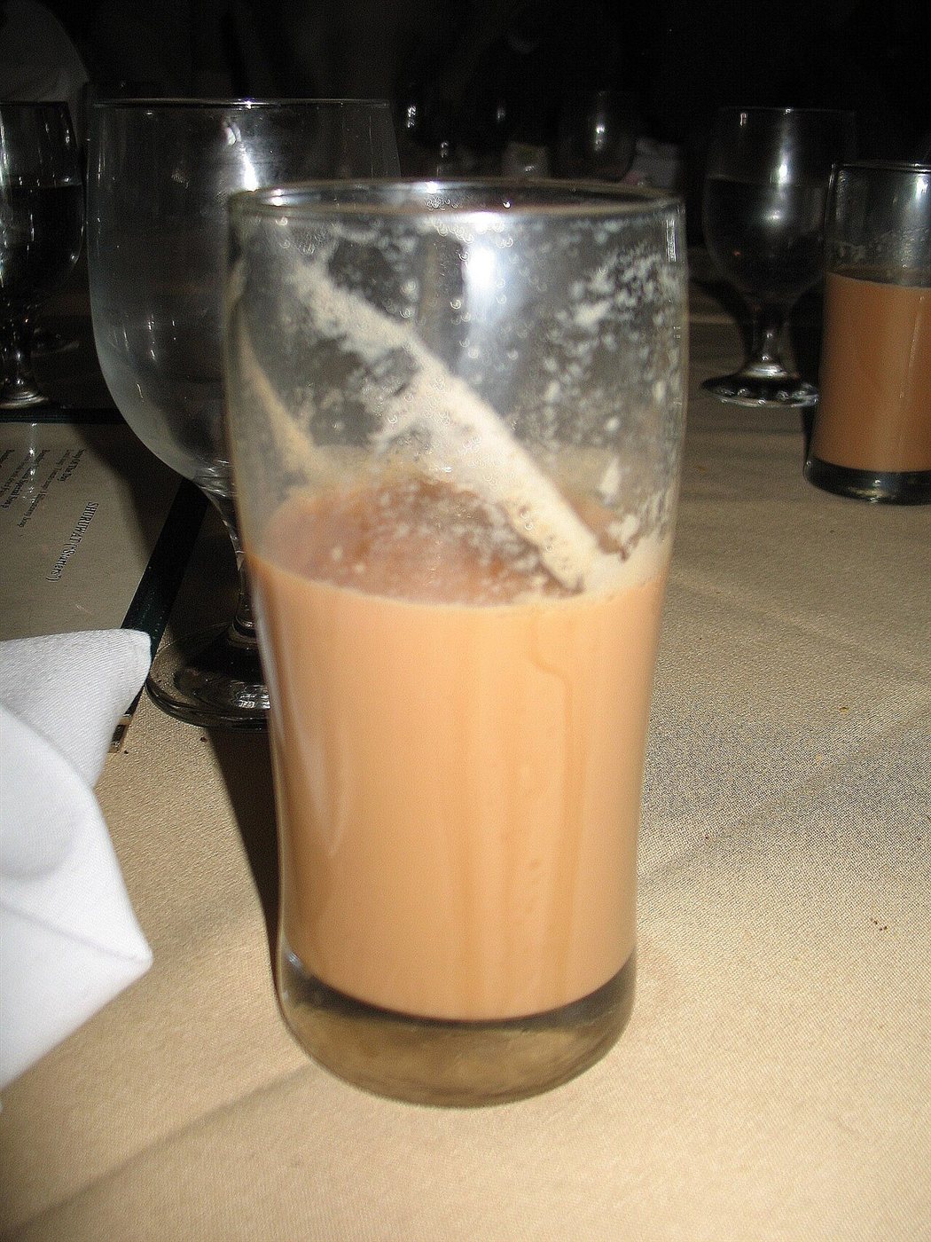 Masala chai being poured into a glass