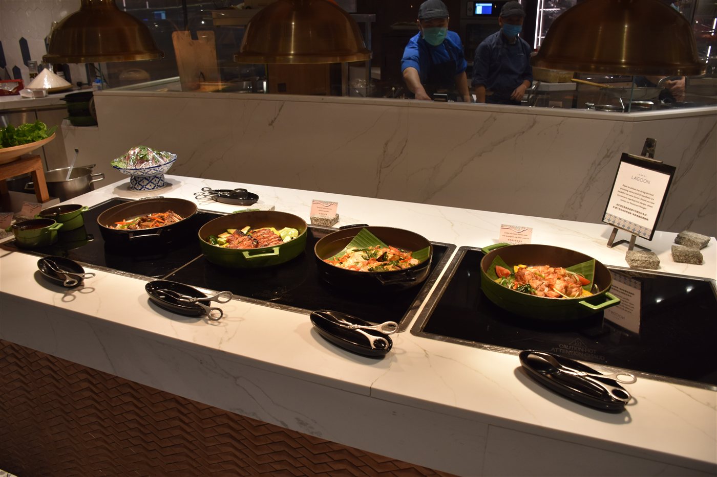 Selection of Indian curries in serving bowls at a buffet counter