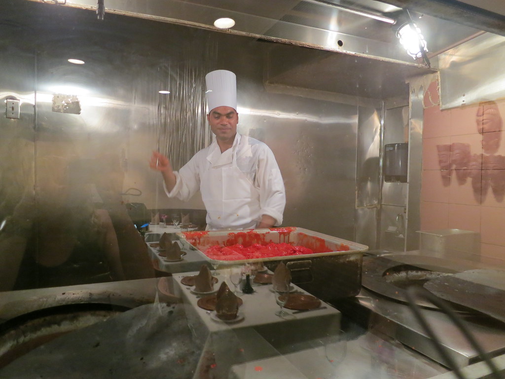 Chef working over a live charcoal tandoor